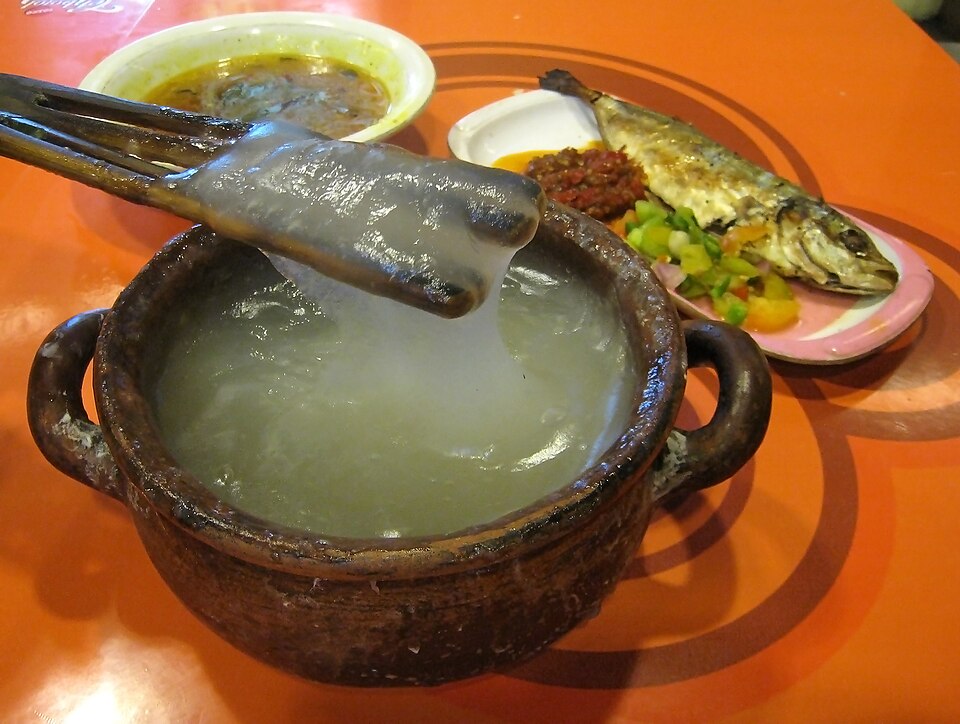 Papeda disajikan dengan kuah kuning dan ikan bakar tude.